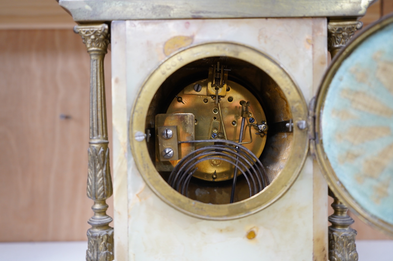 An early 20th century marble and onyx mantel clock with enamel dial with pendulum, no key, 32cm high. Condition - fair, untested